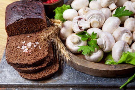 Fresh champignon mushrooms on wooden tableの写真素材