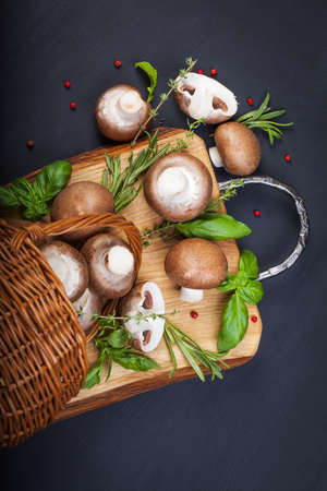 Fresh champignon mushrooms on wooden tableの写真素材