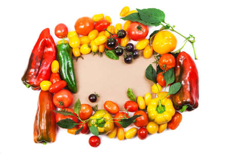 Assorted tomatoes and vegetables isolated on white background. Photo for your design