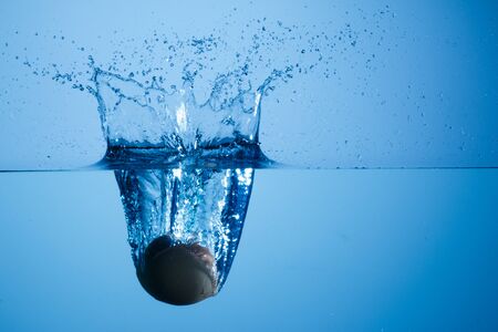 egg falling into the waterの写真素材