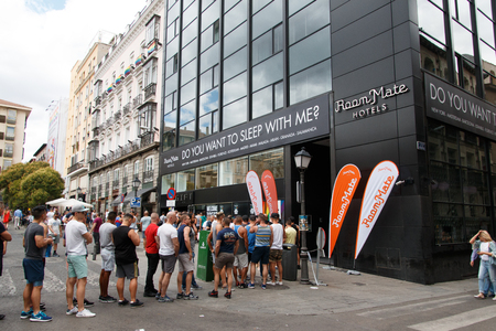 June, 30 2017. Madrid, Spain Group of friends celebrating gay pride party in Madrid and waiting to enter a hotel with a curious sloganのeditorial素材