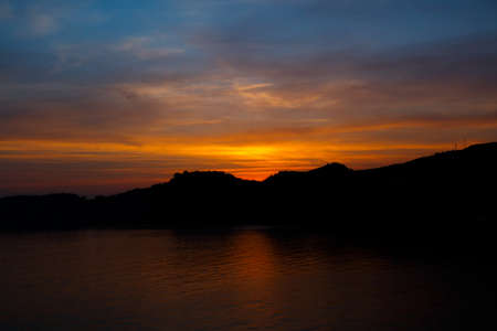 Sunset landscape with orange skyの写真素材
