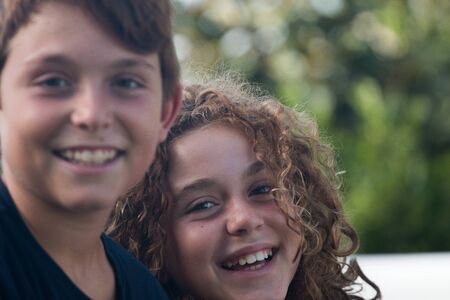 Couple of preteen brothers photographed in a gardenの写真素材