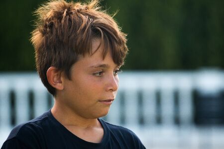 Close-up of young boy in a gardenの写真素材