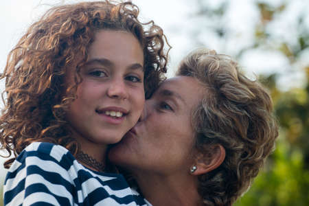 mother with her preteen girl in affectionate positionの写真素材