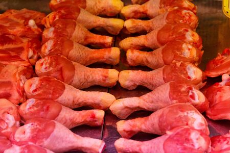 chicken thighs in the showcase of a butcher shopの写真素材