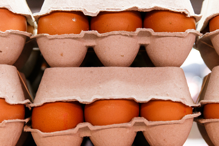 carton of fresh eggs ready for sale in a marketの写真素材