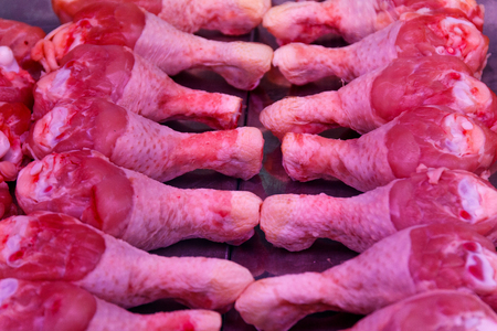 chicken thighs in the showcase of a butcher shopの写真素材