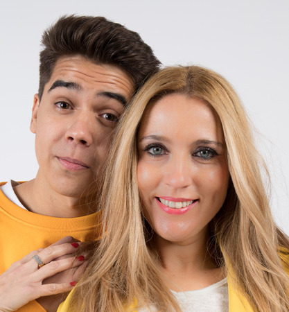 Mother and son posing in a photographic studio with white backgroundの写真素材