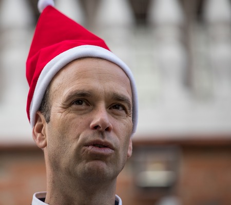 Close-up posing with Santa Claus hat in the garden of the houseの写真素材