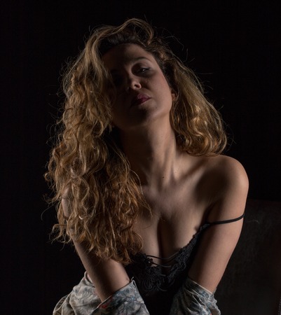 Studio photo shoot for a blonde girl with wavy hairの写真素材