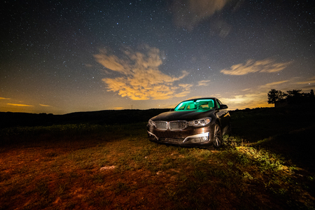 Long night photography of a car with green color illuminated interioの写真素材