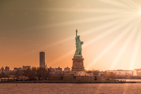 Taking photographs of the Statue of Liberty at sunsetの写真素材