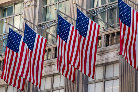 American flags on the facade of wall street in Manhattanの写真素材