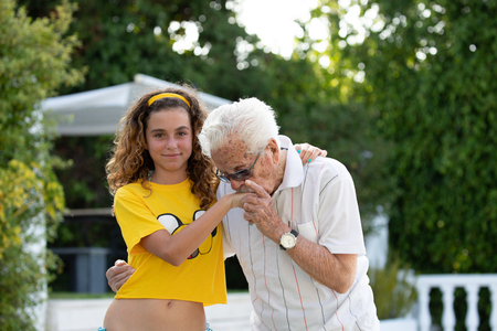 portrait of a great-grandfather of more than 100 years and his great-granddaughter of 10 years oldの写真素材