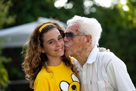 portrait of a great-grandfather of more than 100 years and his great-granddaughter of 10 years oldの写真素材