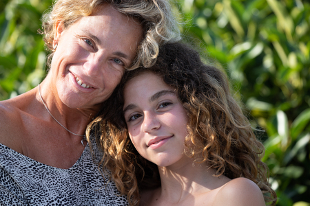 Portrait of mother and daughter in a garden during their holidaysの写真素材