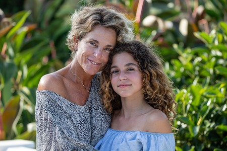 Portrait of mother and daughter in a garden during their holidaysの写真素材