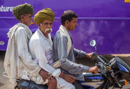 Jaipur, India, 18th to 22nd September 2018 A group of three men travel on a motorcycle without a helmet or proper clothing through the streets of Jaipur.のeditorial素材
