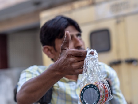 Jaipur, India, 18th to 22nd September 2018 A man with mobility problems offers mirrors to tourists to earn some money.のeditorial素材