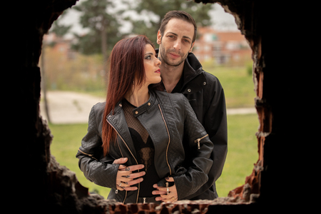 Pictures of a couple in black and hard looking clothes in different settingsの写真素材