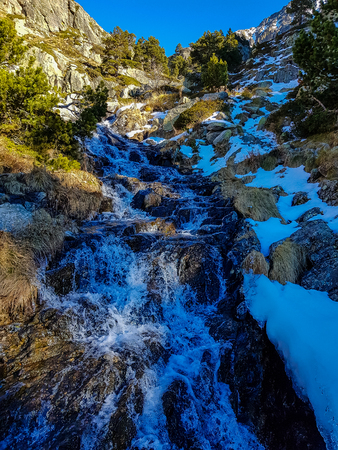 Photograph of a mountainous and snowy landscape on a sunny day in Andorraの写真素材