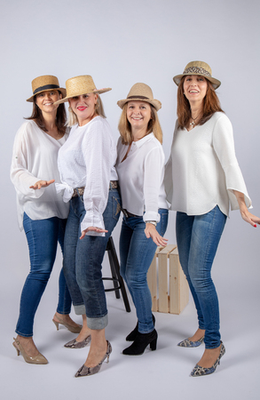 Diversion of four friends in a photographic studio in foot and with hat.の写真素材