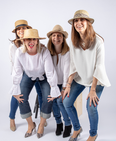 Diversion of four friends in a photographic studio in foot and with hat.の写真素材