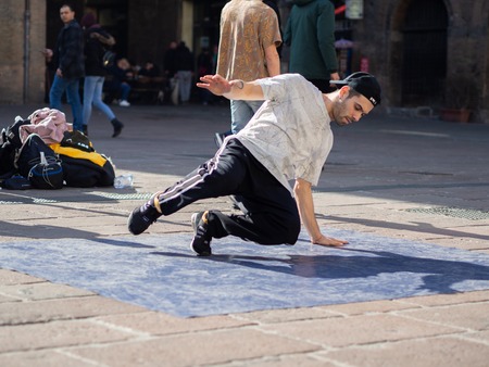 February, 16 2019 Bologna, Italy. Some boys dance break dance in the middle of a street in Bologna, Italy and in front of a church.のeditorial素材
