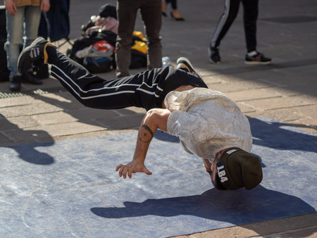February, 16 2019 Bologna, Italy. Some boys dance break dance in the middle of a street in Bologna, Italy and in front of a church.のeditorial素材