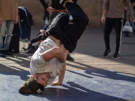 February, 16 2019 Bologna, Italy. Some boys dance break dance in the middle of a street in Bologna, Italy and in front of a church.のeditorial素材