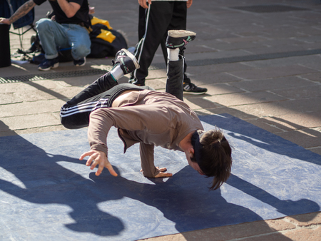 February, 16 2019 Bologna, Italy. Some boys dance break dance in the middle of a street in Bologna, Italy and in front of a church.のeditorial素材