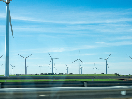 Pictures of wind energy mills from a car on the motorwayの写真素材