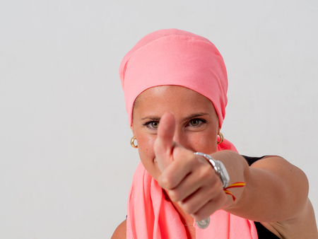 Young girl with pink handkerchief on her head and whiteの写真素材