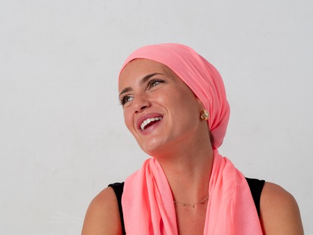 Young girl with pink handkerchief on her head and whiteの写真素材