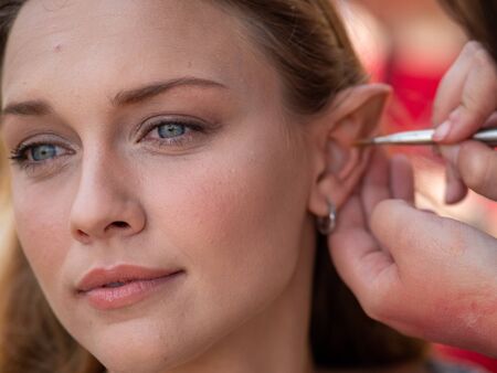 Makeup on the ears to a model to turn her into an elfの写真素材