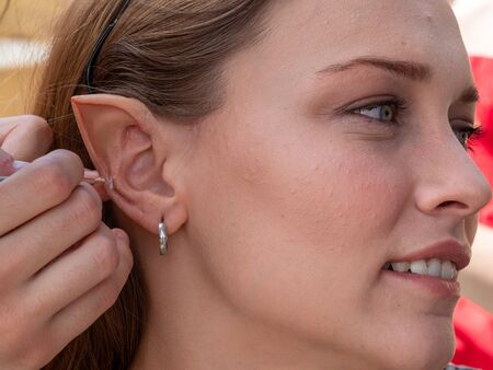 Makeup on the ears to a model to turn her into an elfの写真素材