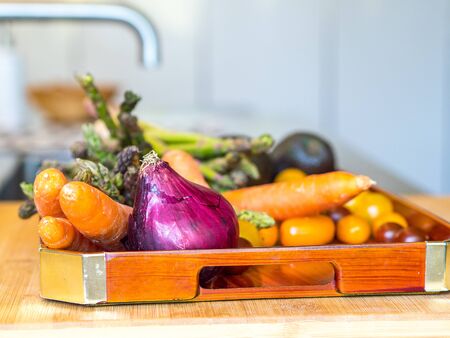 Vegetable tray on the top of a modern kitchen ready to be preparedの写真素材