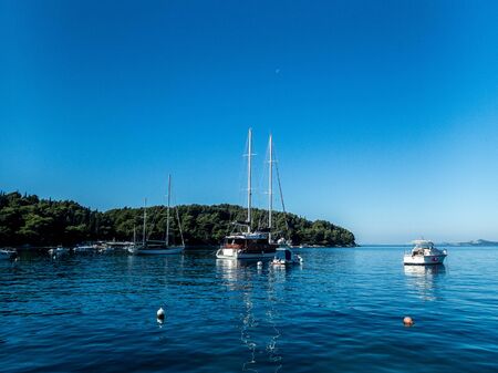 Stock photo of sailboats moored in the calm sea in Cavtat, Croatia. Travel concept