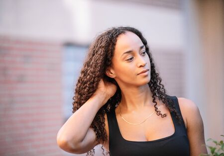 photo of a black girl with long hair posing and wearing sports clothes. Fitnessの写真素材