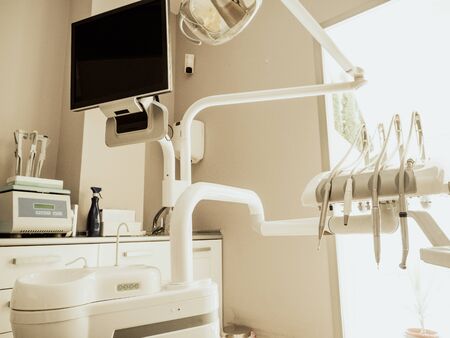A dentist's clinic. Working armchair with utensils and tools.の写真素材