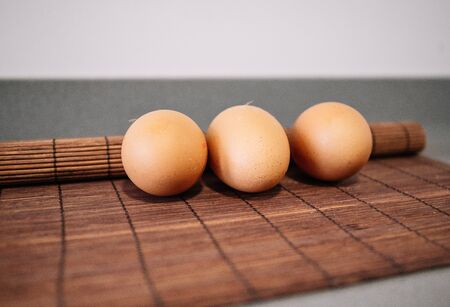 Row of three raw chicken eggsの写真素材
