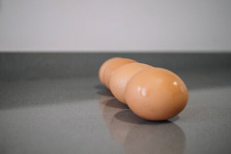 Row of three raw chicken eggsの写真素材