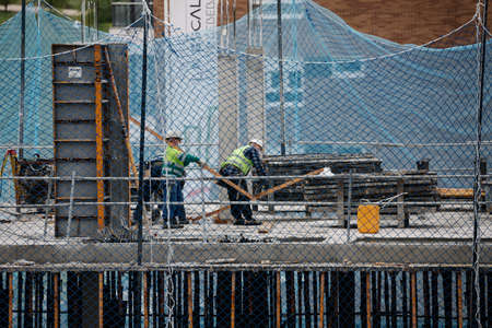 April, 15 2020, in Madrid, Spain some colleagues from the construction industry are working together...