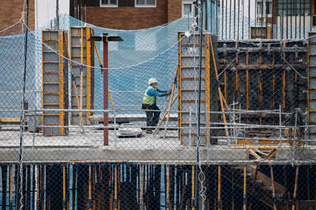 April, 15 2020, in Madrid, Spain a construction worker working with a mask during the covid-19 pandemicのeditorial素材