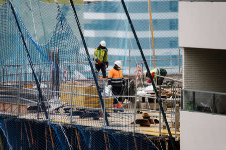 April, April 15 2020, in Madrid, Spain workers work with protective masks to avoid being infected by the covid virus 19のeditorial素材