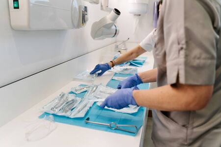 Picking up medical instruments for dentists after an operationの写真素材