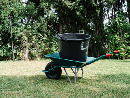 ubber bucket on a wheelbarrow in a big gardenの写真素材