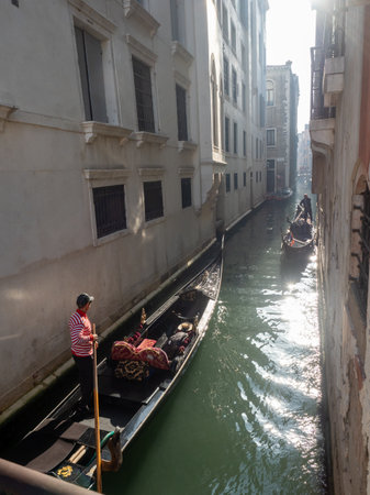 October 31, 2022 - Venice, Italy: Gondolas sailing in a canal in Venice. Tourism concept.の写真素材