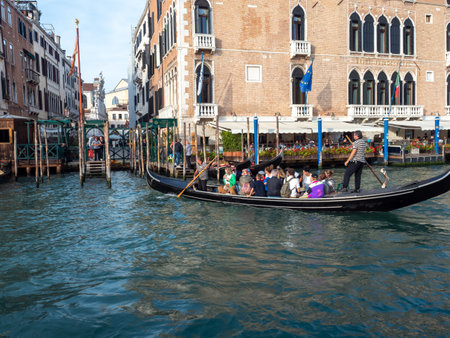 October 31, 2023 - Venice, Italy: Group of tourists on a gondola in the grand canal in Venice. Tourism concept.の写真素材